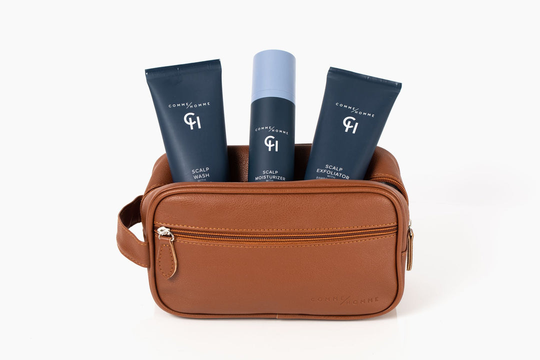 Comme Homme Scalp Wash, Moisturizer, and Exfoliator on display in leather toiletry bag